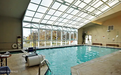 a view of a patio with a table chairs and a wooden floor