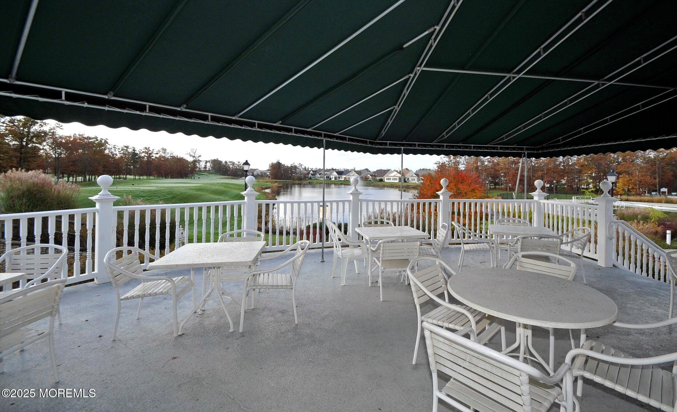 58 Spyglass Drive Jackson, NJ 08527 - Photo 24 of 32 a view of a patio with a table chairs and a wooden floor