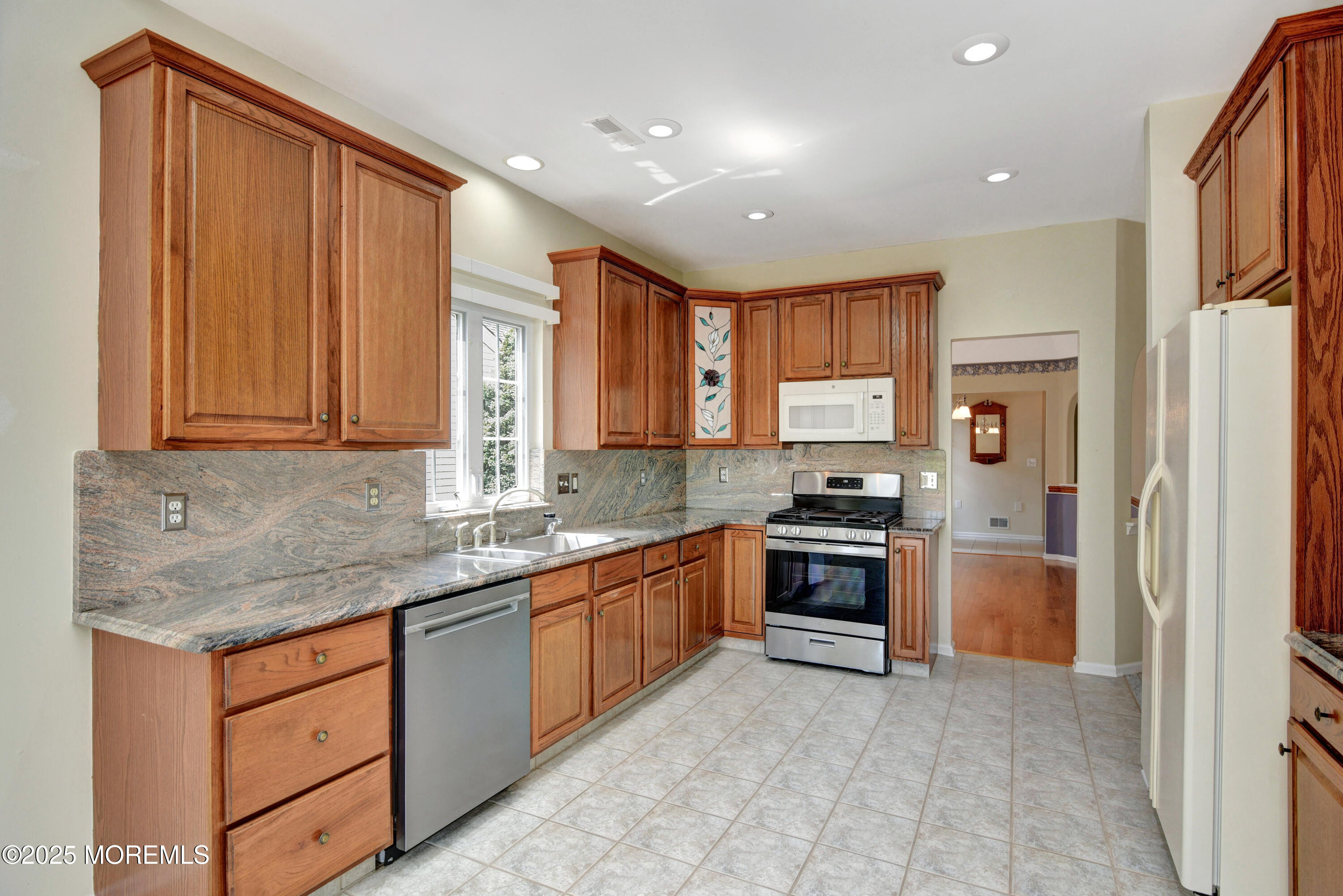 58 Spyglass Drive Jackson, NJ 08527 - Photo 3 of 32 a kitchen with stainless steel appliances granite countertop a stove sink and cabinets