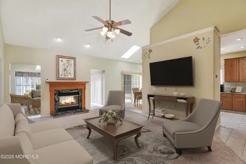 a living room with furniture a fireplace and a flat screen tv