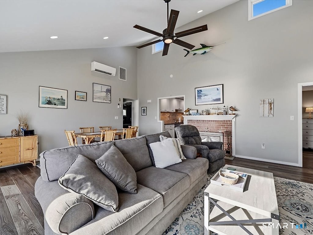 75 Shore Road Clinton, CT 06413 - Photo 11 of 40 a living room with furniture and a wooden floor