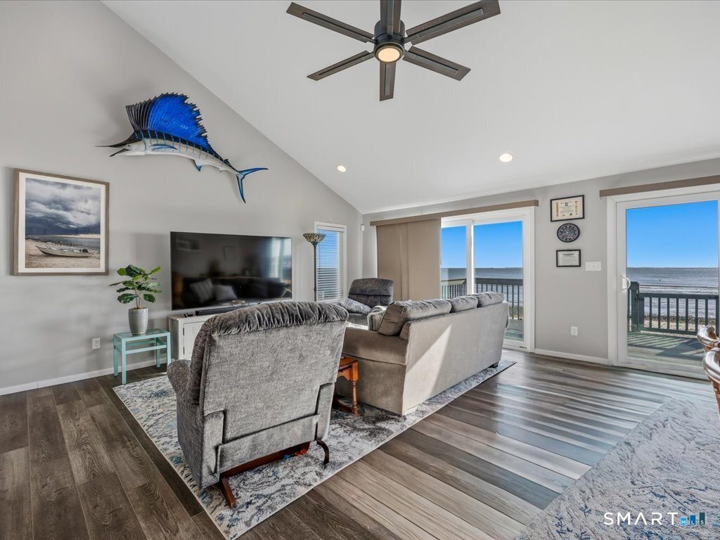 75 Shore Road Clinton, CT 06413 - Photo 12 of 40 a living room with furniture and a flat screen tv
