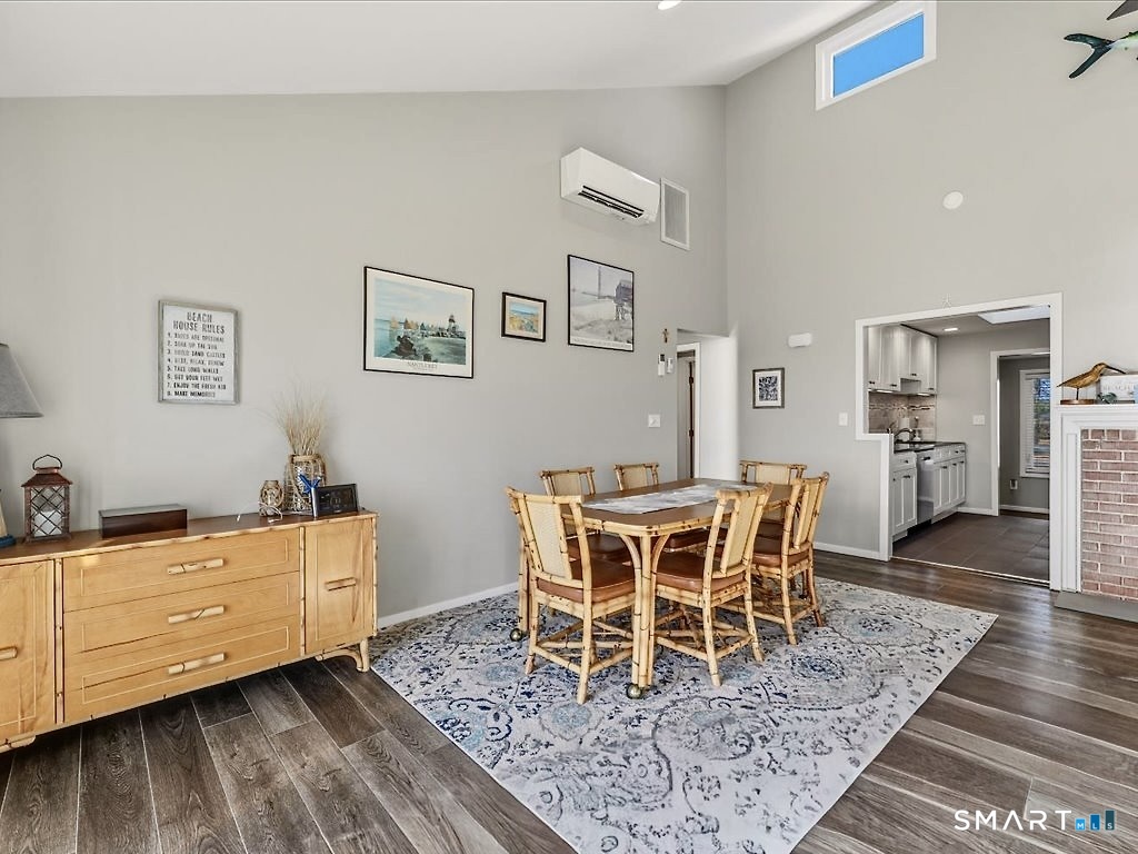 75 Shore Road Clinton, CT 06413 - Photo 13 of 40 a dining room with furniture wooden floor and a rug