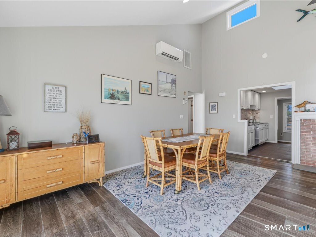 75 Shore Road Clinton, CT 06413 - Photo 15 of 40 a dining room with furniture wooden floor and a rug