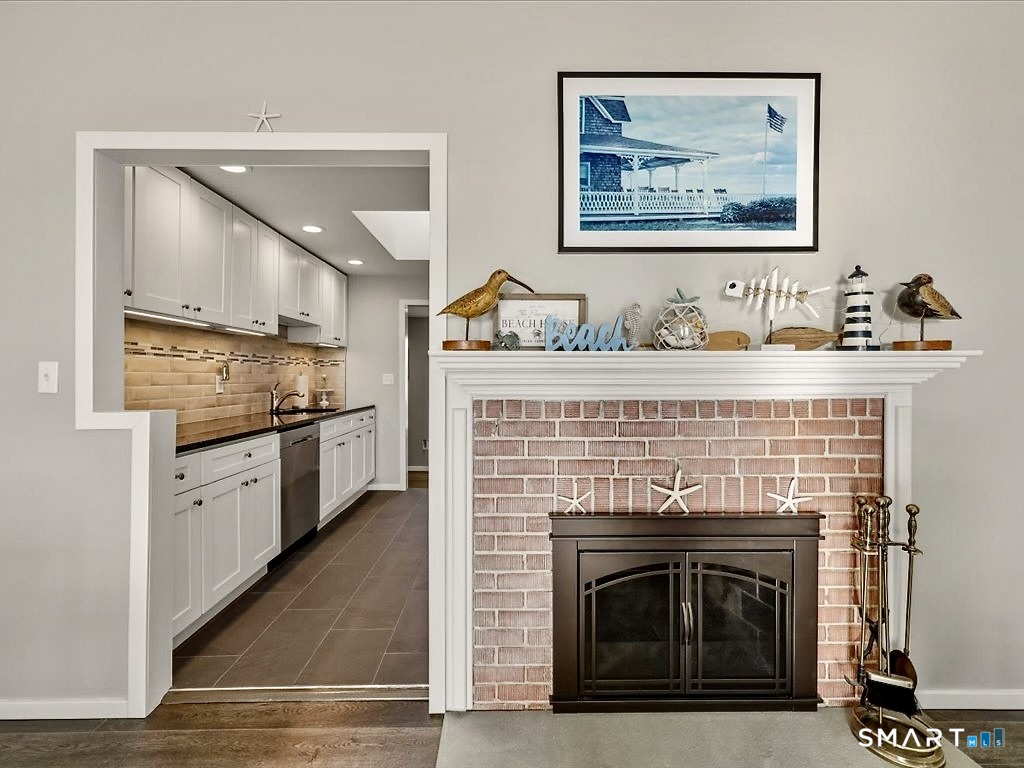 75 Shore Road Clinton, CT 06413 - Photo 16 of 40 a kitchen with stainless steel appliances granite countertop a stove top oven
