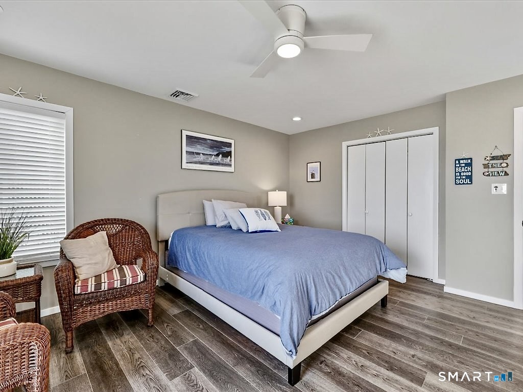 75 Shore Road Clinton, CT 06413 - Photo 22 of 40 a bedroom with a bed chair and a window
