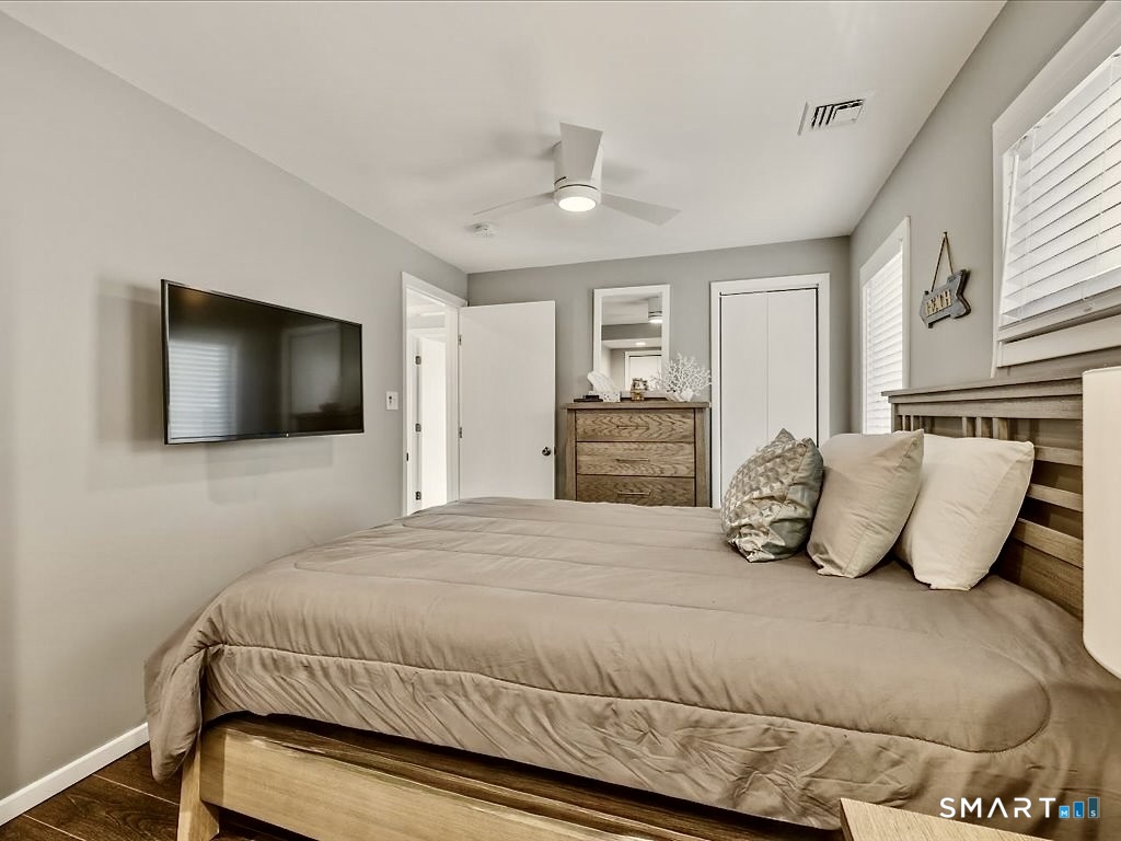 75 Shore Road Clinton, CT 06413 - Photo 26 of 40 a bedroom with a large bed and a flat screen tv