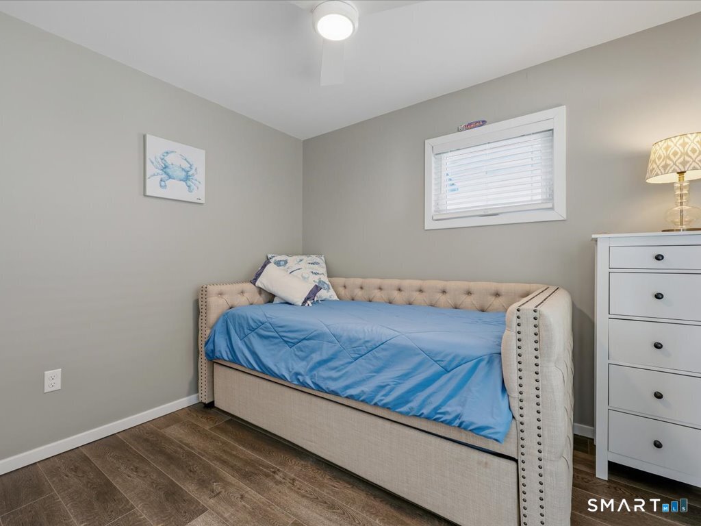 75 Shore Road Clinton, CT 06413 - Photo 27 of 40 a bed sitting in a bedroom next to a window