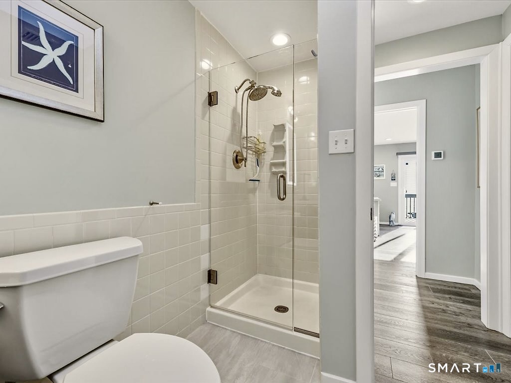 75 Shore Road Clinton, CT 06413 - Photo 28 of 40 a bathroom with a shower a toilet and a shower