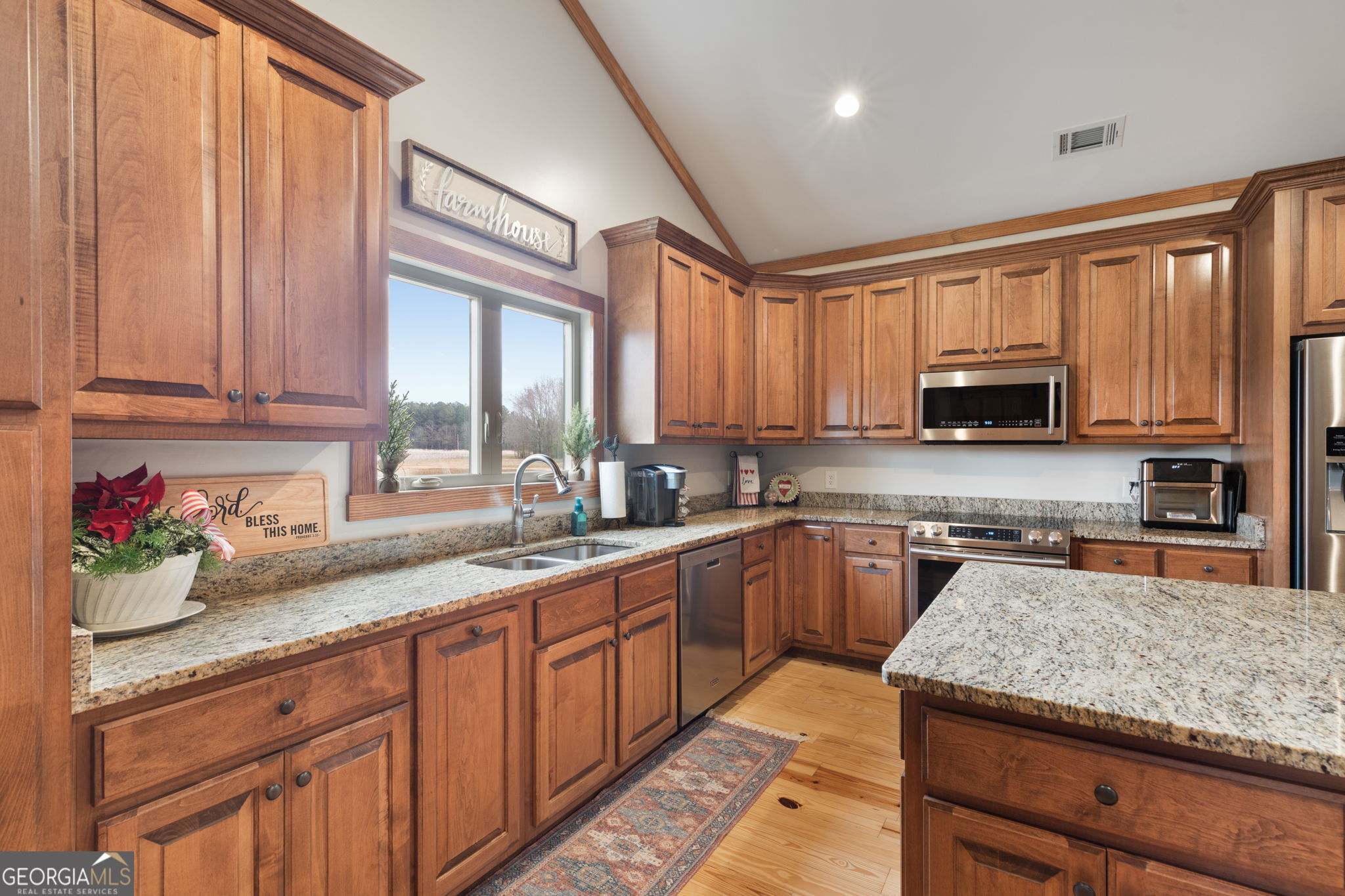 2770 Jones Road Sandersville, GA 31082 - Photo 21 of 80 a kitchen with stainless steel appliances granite countertop wooden cabinets a sink and a window