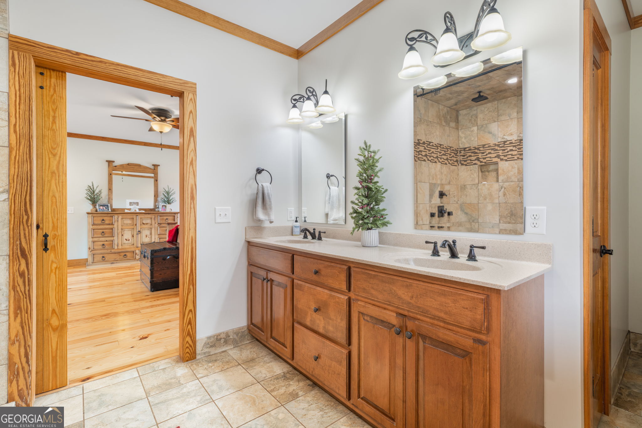 2770 Jones Road Sandersville, GA 31082 - Photo 34 of 80 a spacious bathroom with a double vanity sink a mirror and a shower