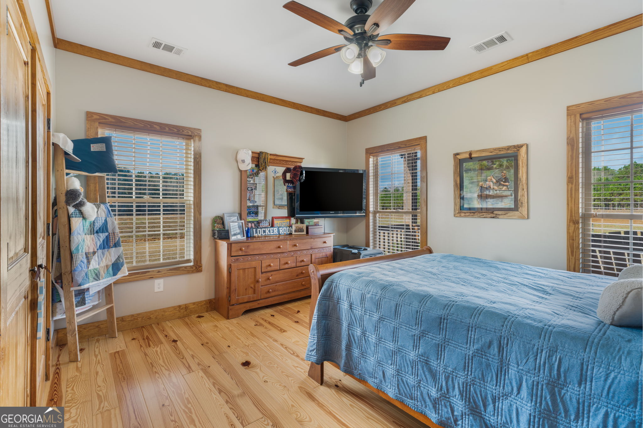 2770 Jones Road Sandersville, GA 31082 - Photo 44 of 80 a bedroom with a large bed a flat tv screen and dresser