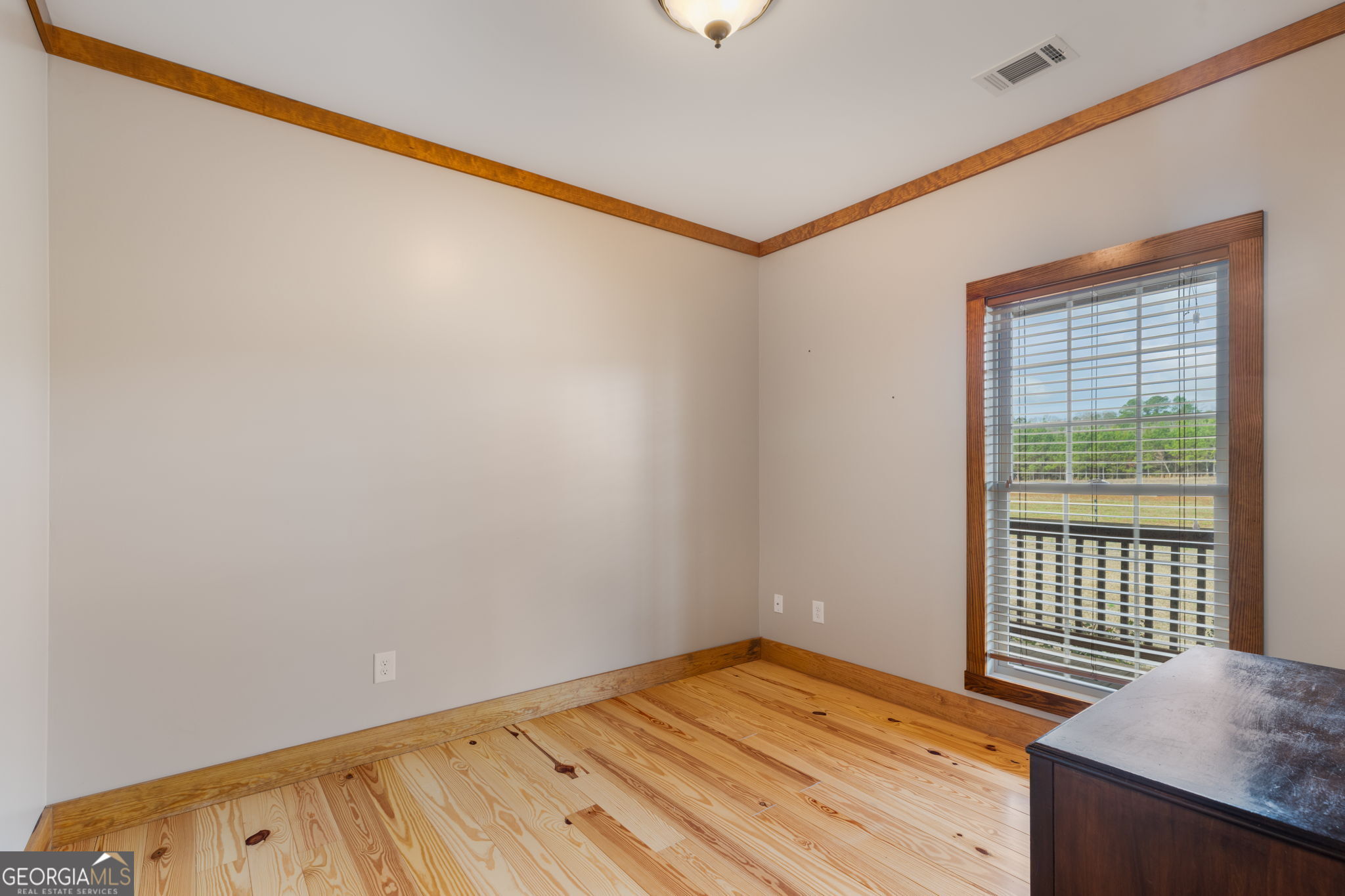 2770 Jones Road Sandersville, GA 31082 - Photo 46 of 80 a view of empty room with wooden floor and fan
