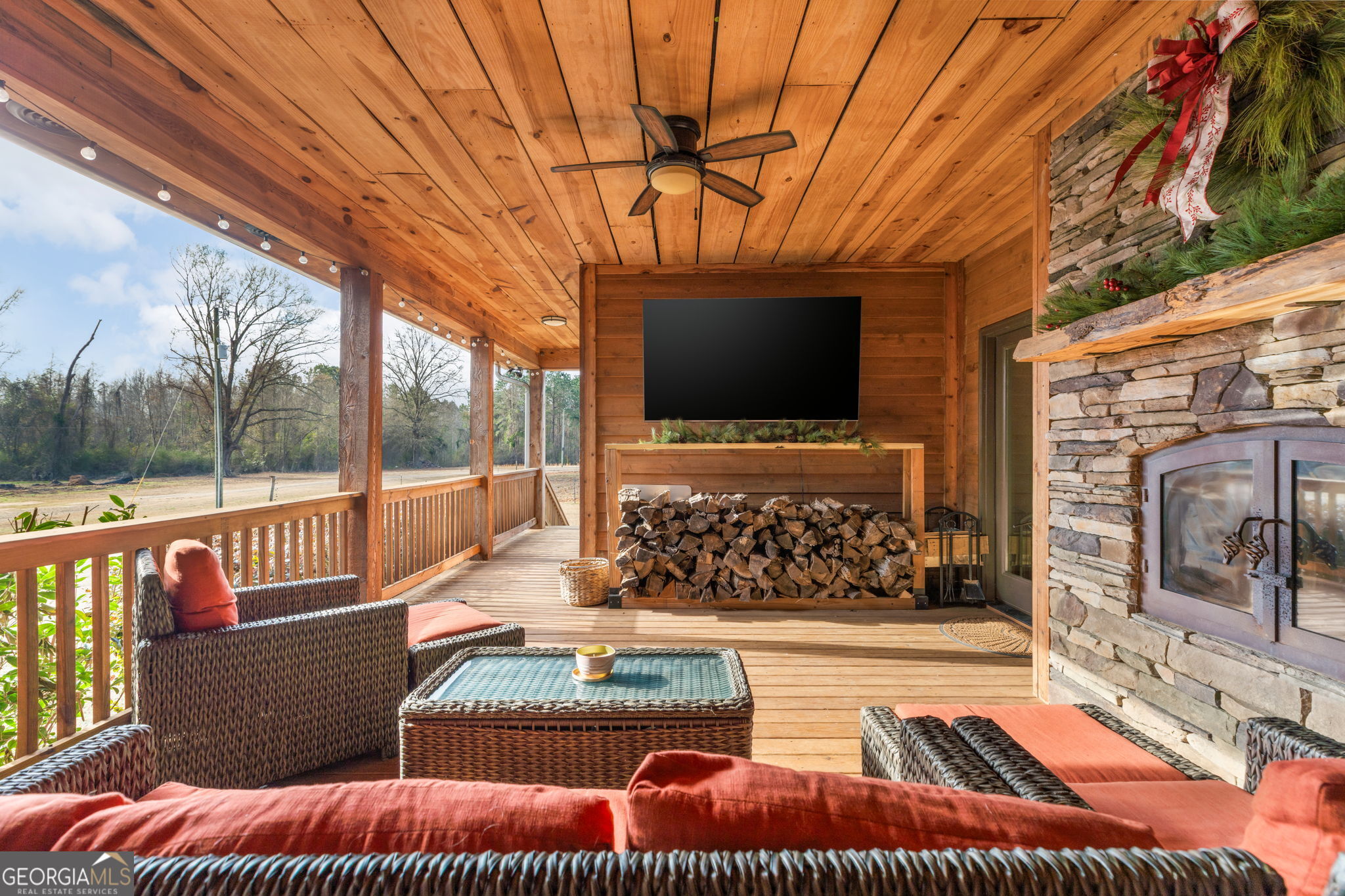 2770 Jones Road Sandersville, GA 31082 - Photo 51 of 80 a living room with large stone wall and a flat screen tv