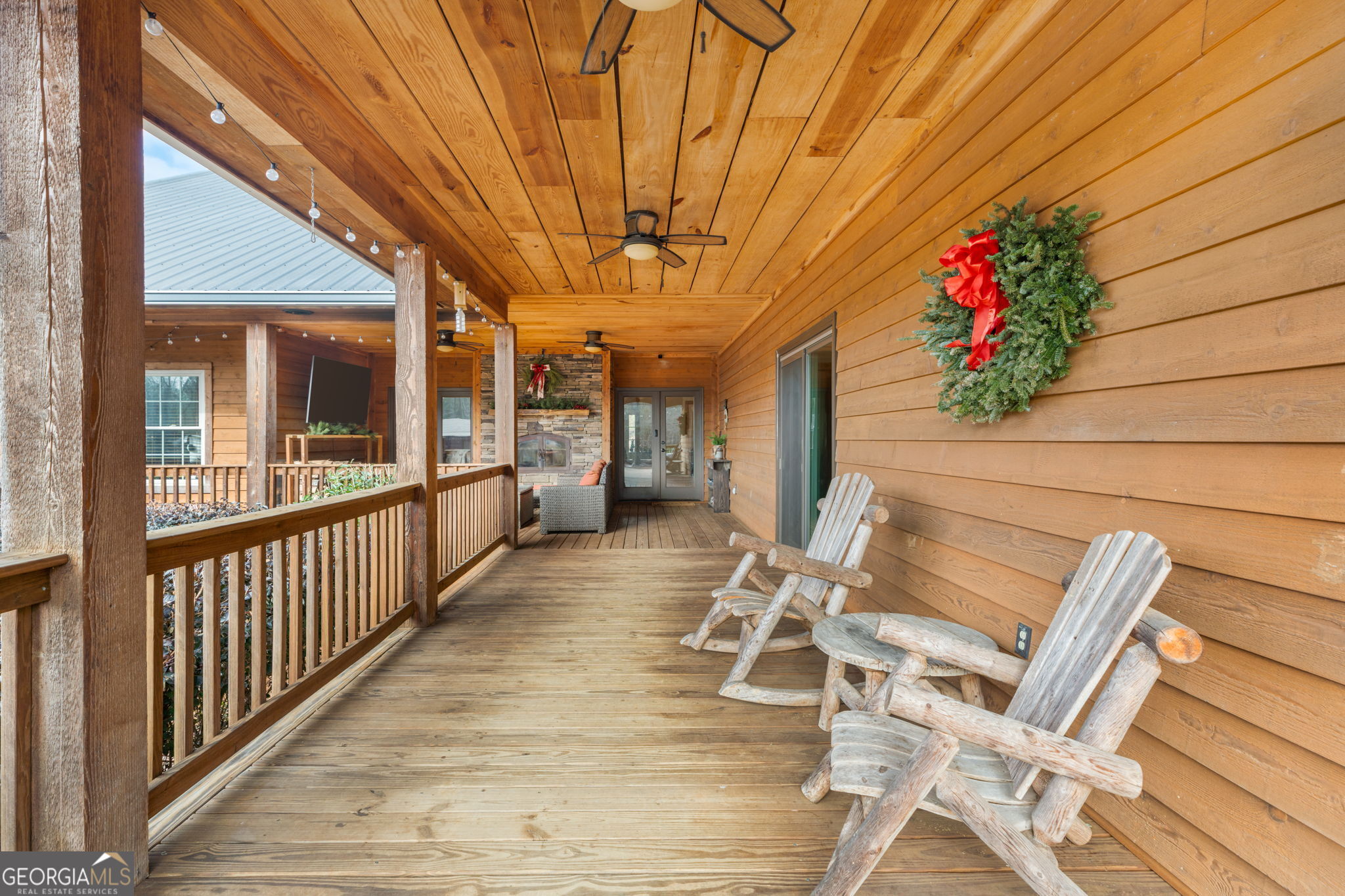 2770 Jones Road Sandersville, GA 31082 - Photo 53 of 80 a view of a patio with table and chairs with wooden floor and fence