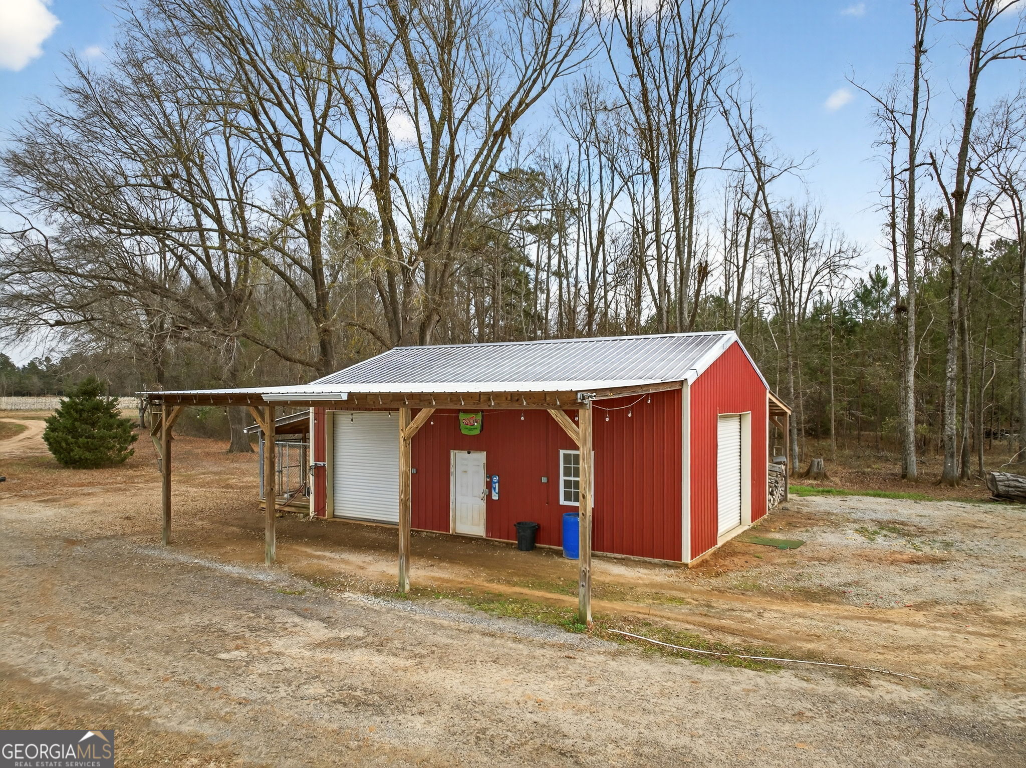 2770 Jones Road Sandersville, GA 31082 - Photo 58 of 80 a view of a barn with a yard and large tree