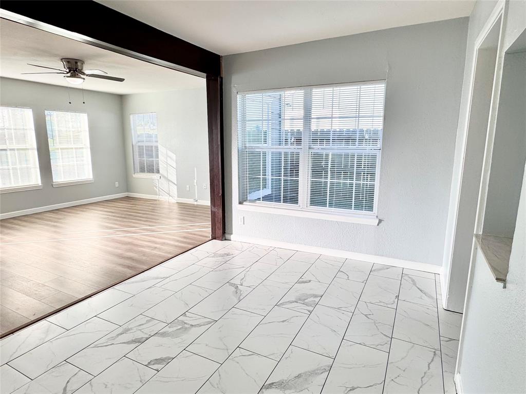 202 North Riverside Drive Fort Worth, TX 76111 - Photo 11 of 25 a view of an empty room with wooden floor and a window