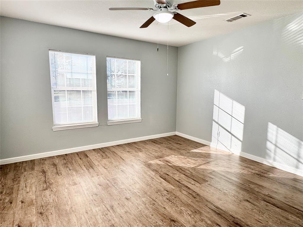202 North Riverside Drive Fort Worth, TX 76111 - Photo 18 of 25 wooden floor in an empty room with a window