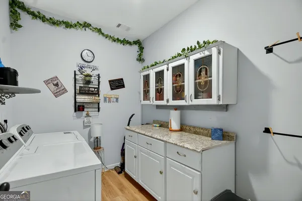 a bathroom with a granite countertop shower a sink and a blue shower