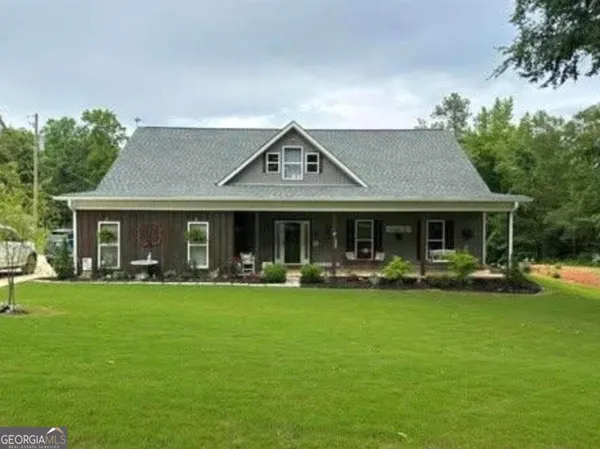 a front view of a house with a garden and patio