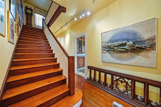 a bedroom with a large bed and a fireplace