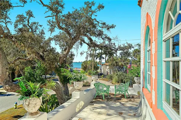 a dining room with wooden floor table and chairs