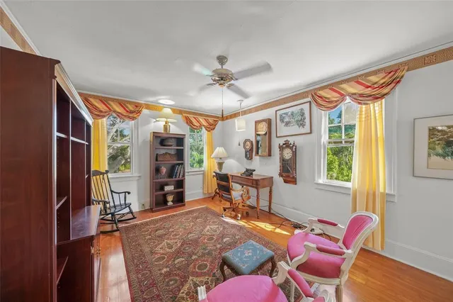 a living room with furniture a fireplace and a floor to ceiling window