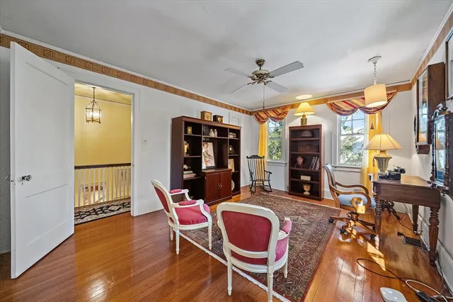 a living room with furniture chandelier and a large window