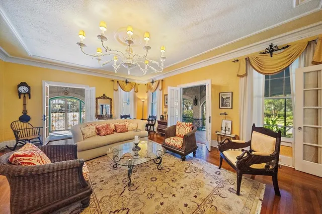 a room with lots of wooden furniture and a floor to ceiling window