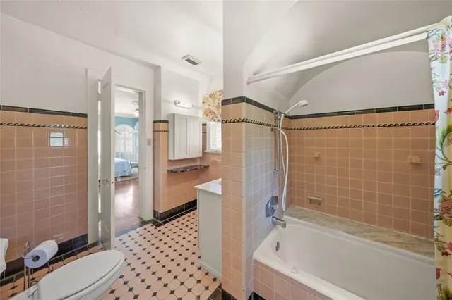 a bathroom with a sink a toilet a mirror and a tub