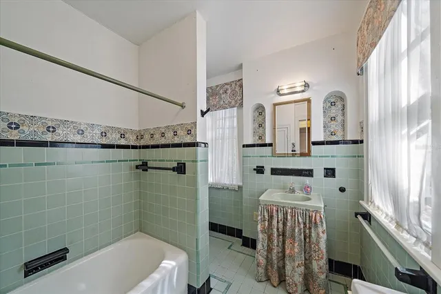 a kitchen with a refrigerator and white cabinets