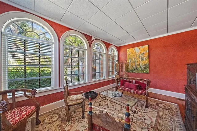 a view of a dining room with furniture a chandelier and wooden floor