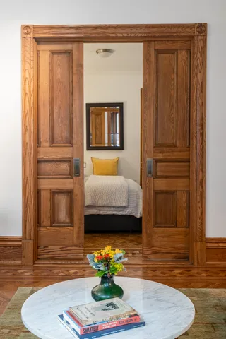 a view of hall way with mirror and furniture