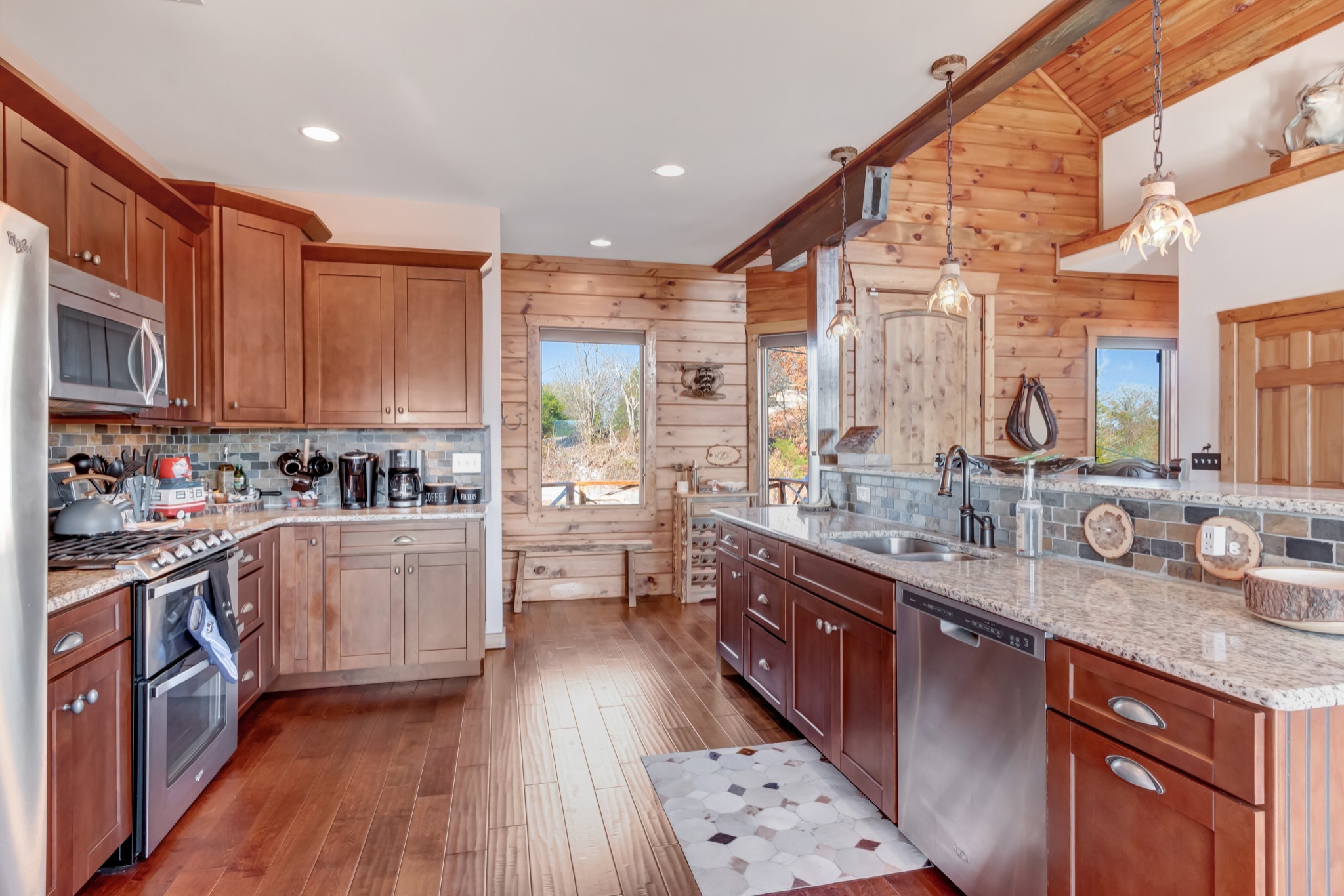 5320 Coconut Ridge Road Smithville, TN 37166 - Photo 26 of 52 a kitchen with stainless steel appliances granite countertop a stove a sink dishwasher and a microwave oven with wooden floor
