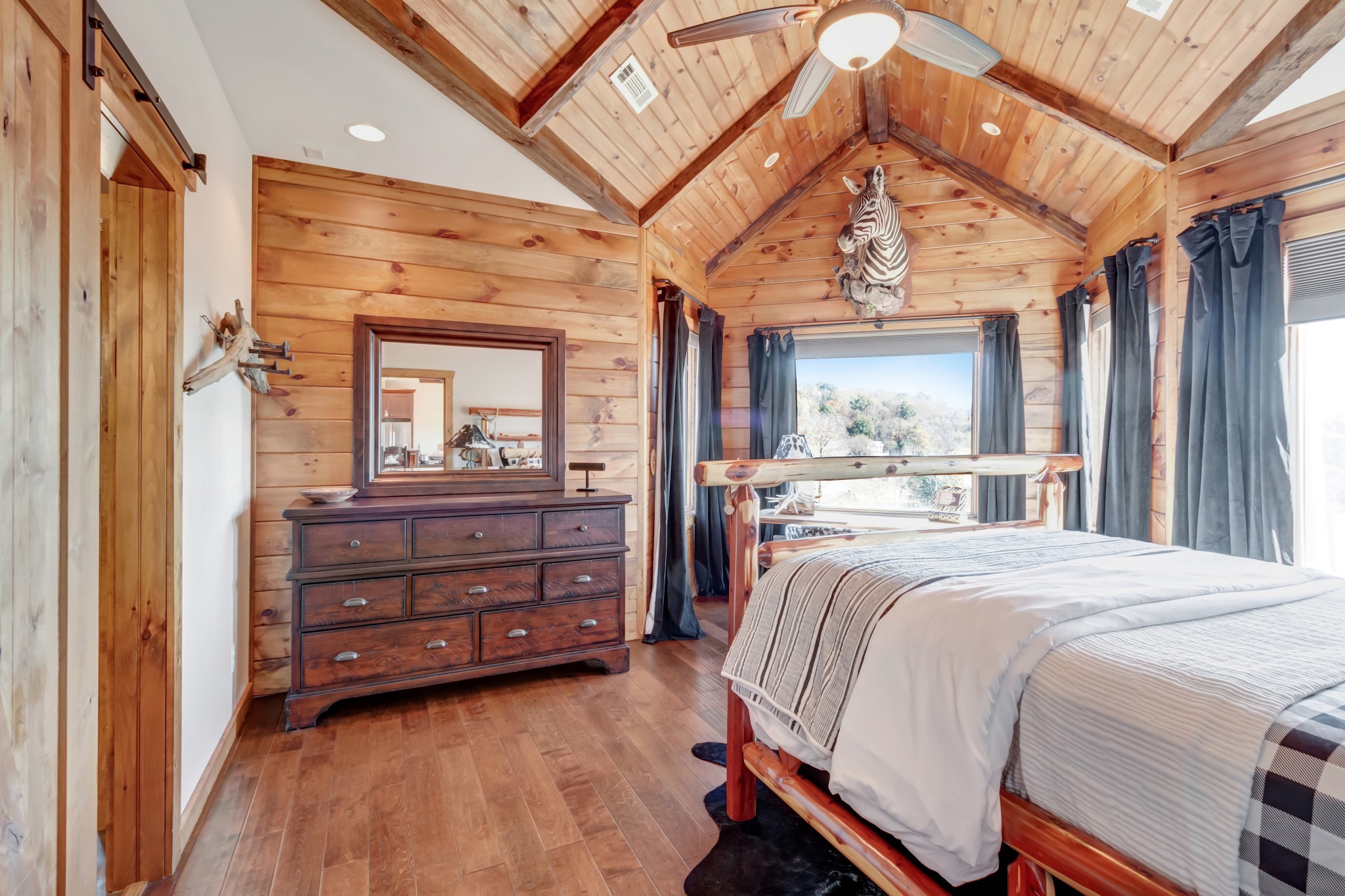5320 Coconut Ridge Road Smithville, TN 37166 - Photo 30 of 52 a spacious bedroom with a bed and a large mirror on the dresser
