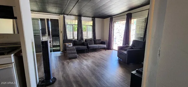a living room with furniture windows and wooden floor