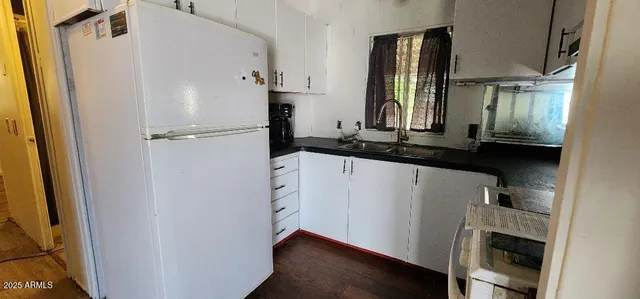 a kitchen with a refrigerator and a sink