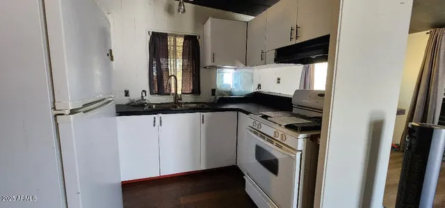 a kitchen with a stove and a refrigerator