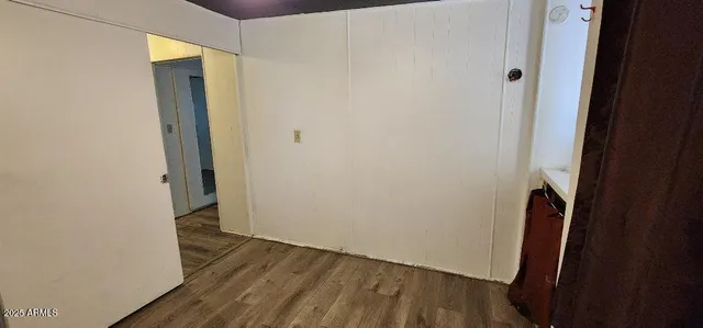 a view of a hallway with wooden floor