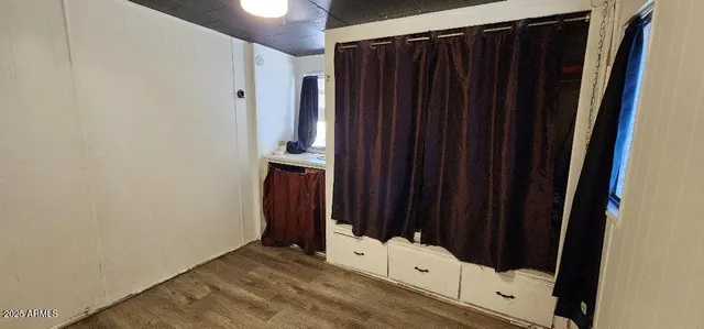 a view of a closet with wooden floor