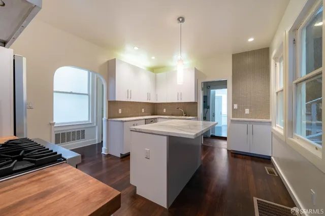 a kitchen with a sink stove and wooden cabinets