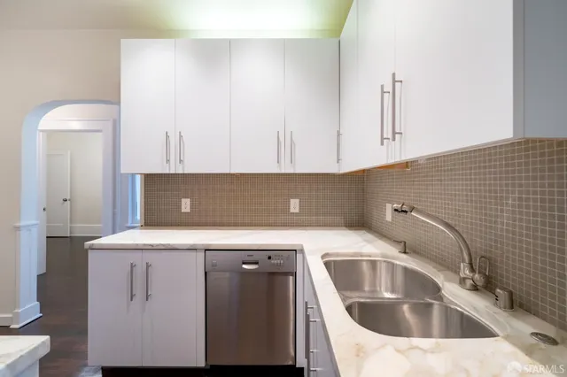 a view of a livingroom with wooden floor and a fireplace