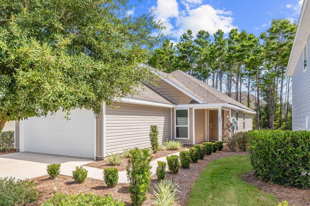 a front view of a house with garden