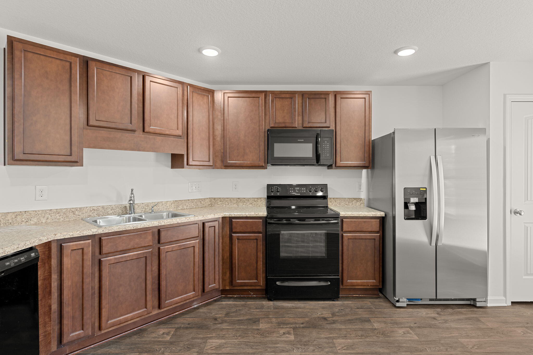 545 Earl Godwin Road Freeport, FL 32439 - Photo 12 of 50 a kitchen with stainless steel appliances granite countertop a stove a refrigerator and a sink