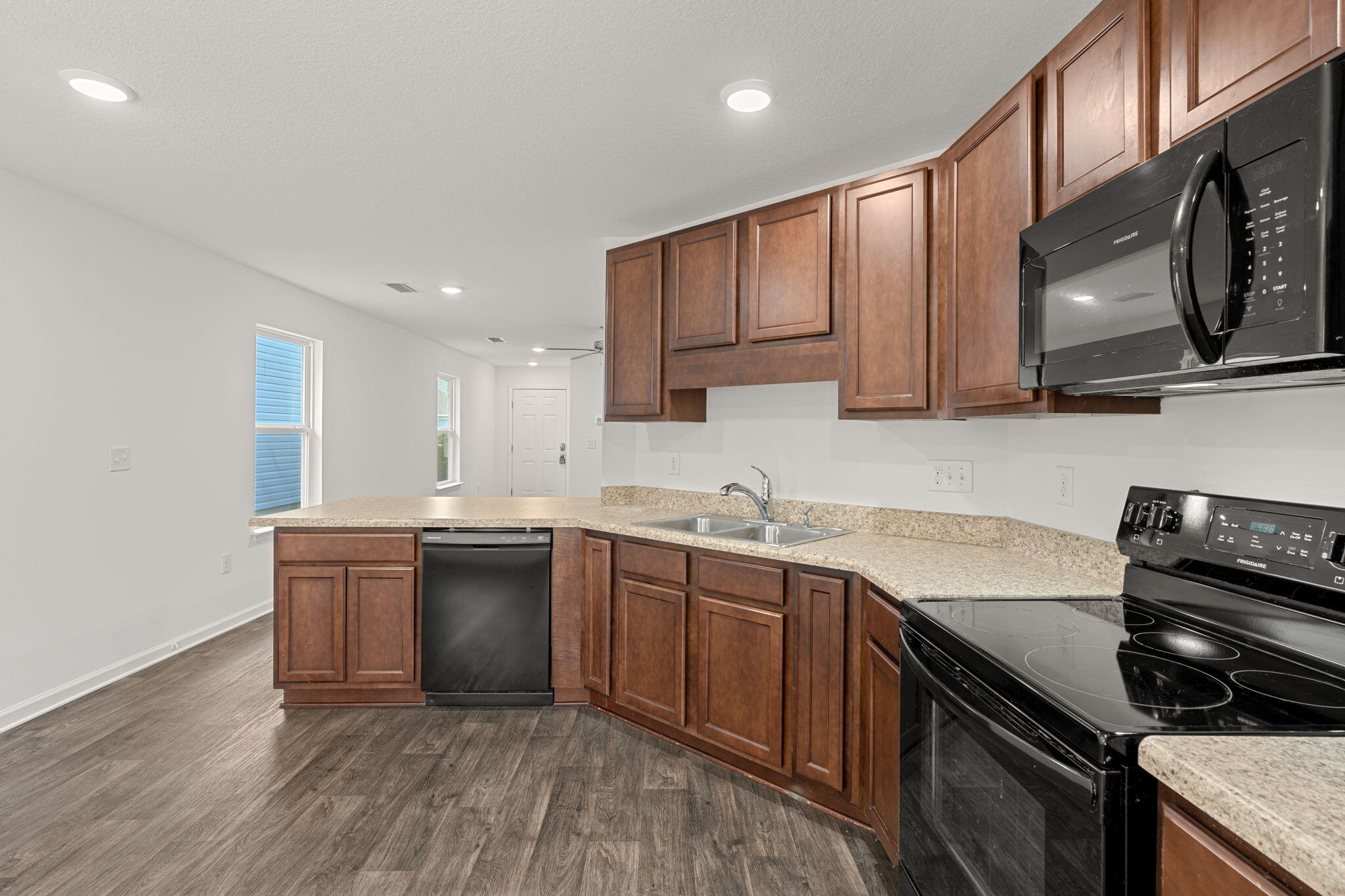 545 Earl Godwin Road Freeport, FL 32439 - Photo 13 of 50 a kitchen with stainless steel appliances granite countertop a sink stove and cabinets