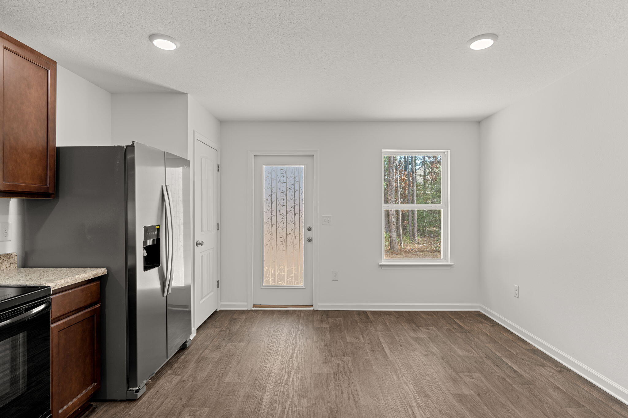 545 Earl Godwin Road Freeport, FL 32439 - Photo 15 of 50 a view of a kitchen with a refrigerator cabinets and wooden floor
