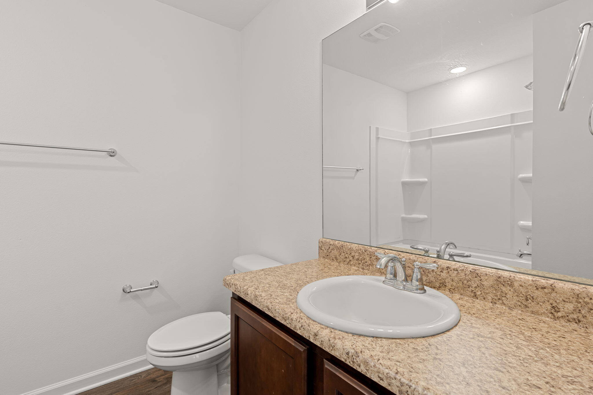 545 Earl Godwin Road Freeport, FL 32439 - Photo 27 of 50 a bathroom with a granite countertop sink toilet and a mirror