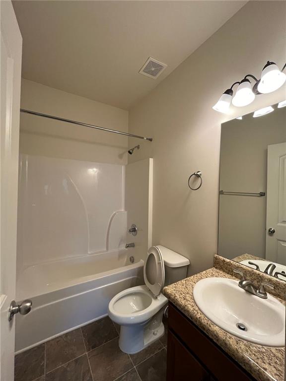 61 Howard Avenue Cartersville, GA 30121 - Photo 11 of 19 a bathroom with a granite countertop sink toilet a mirror and shower