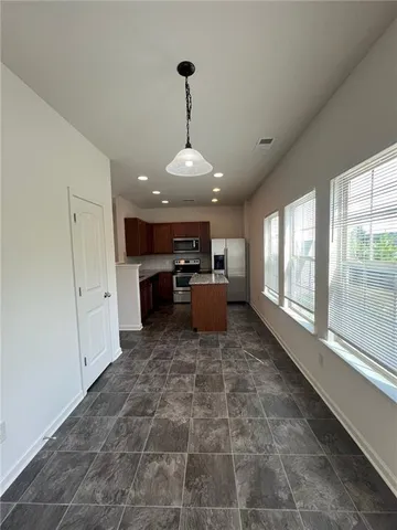 a large room with a large window and furniture