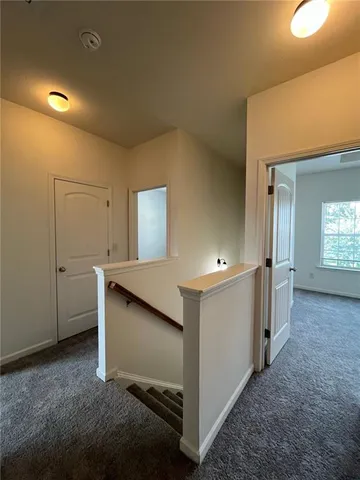 a view of a hallway with bathroom